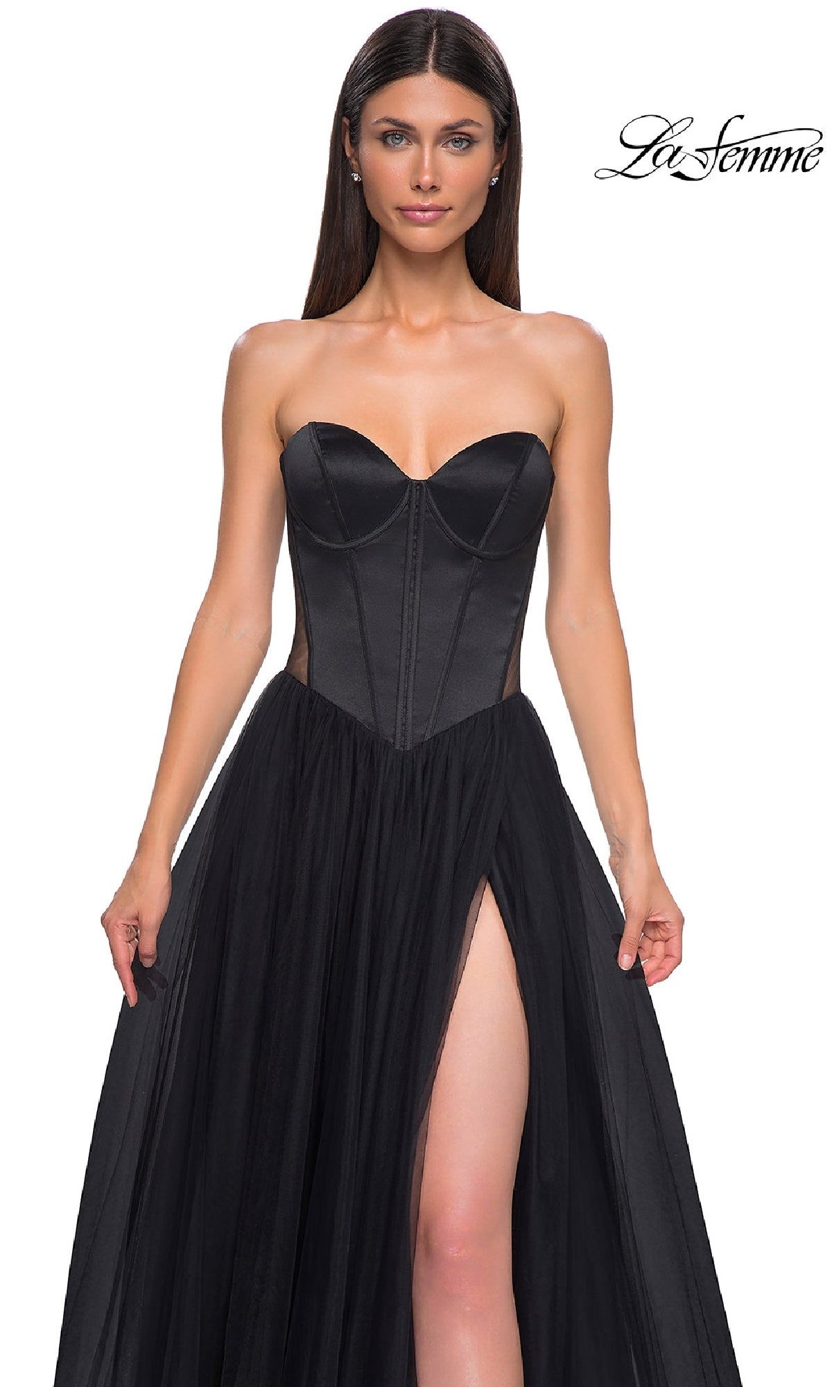 A woman models the La Femme 32771 black strapless long prom dress, featuring a sweetheart neckline, sheer tulle skirt, and thigh-high slit, against a plain white background.